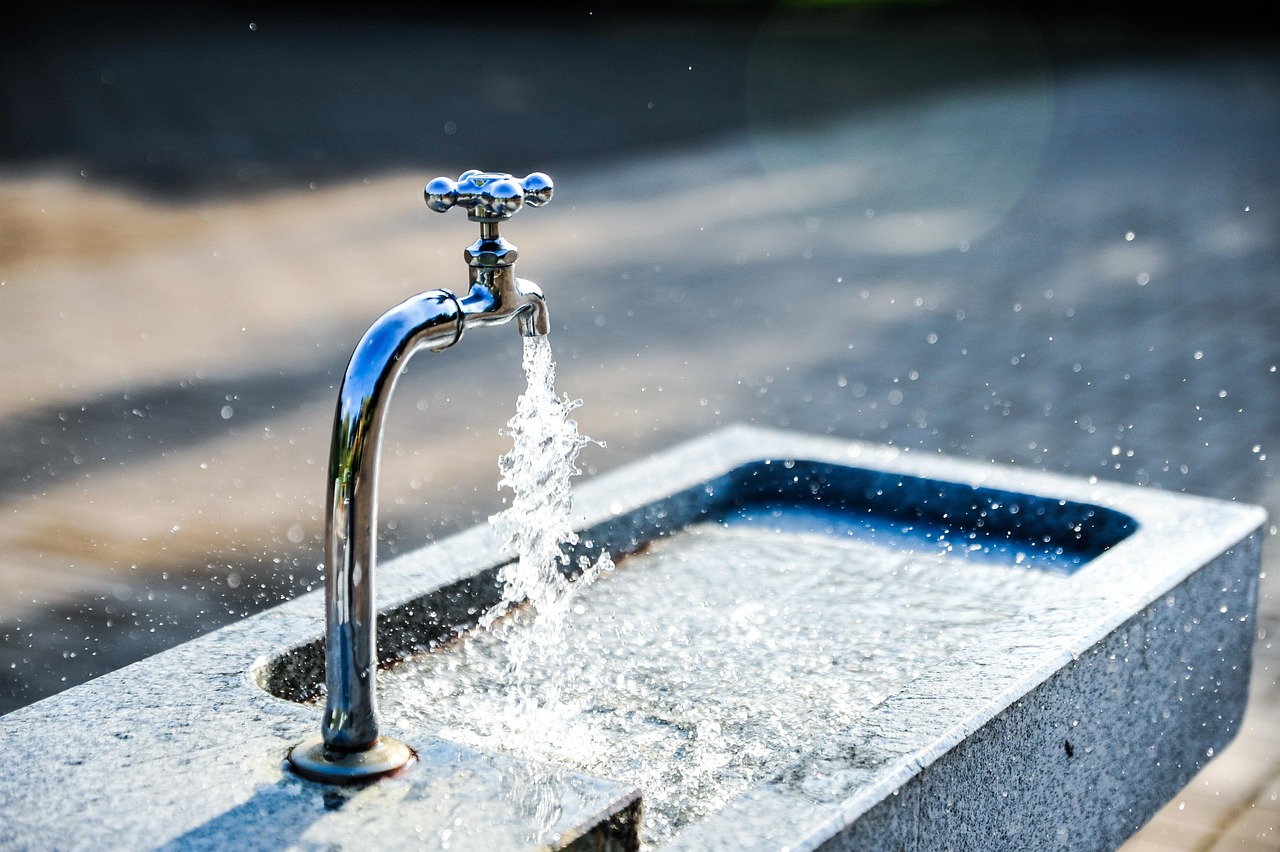Chrome tap with water flowing over stone in Delhi